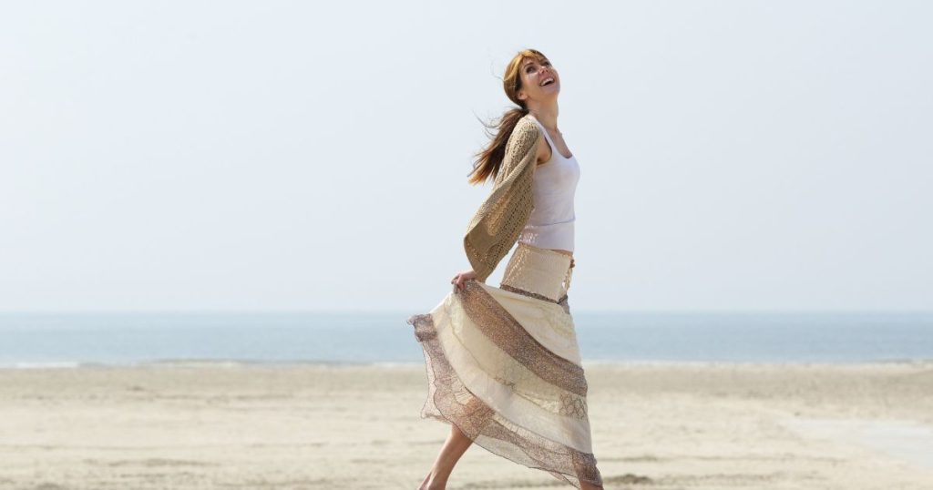 Woman enjoying youthful energy on the beach after receiving NAD+ anti-aging treatment at Hydrate Medical in Charlotte North Carolina