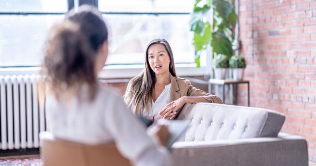 A woman discussing NAD+ therapy in Charlotte, NC, at Hydrate Medical.